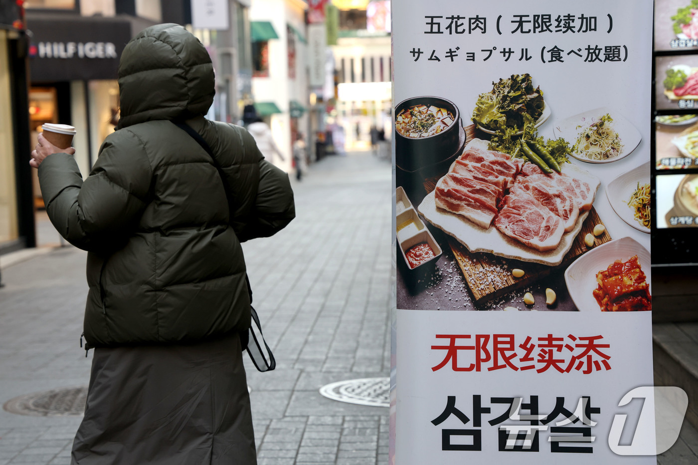 (서울=뉴스1) 이광호 기자 = 23일 서울 중구 명동에서 시민이 한식당 앞을 지나가고 있다.한국소비자원 가격정보포털 참가격에 따르면 지난해 1년 동안 외식비는 최대 5%이상 상승 …