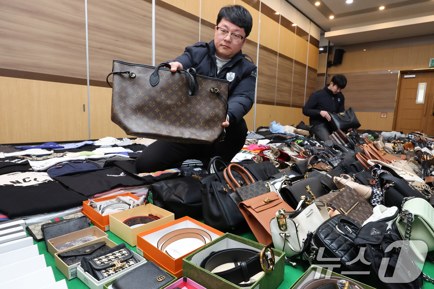 (인천=뉴스1) 황기선 기자 = 27일 오전 인천 중구 인천본부세관에서 열린 '1200억원대 위조 명품 판매 쇼핑몰 운영조직 적발' 브리핑에서 직원들이 압수품을 살펴보고 있다.관세 …