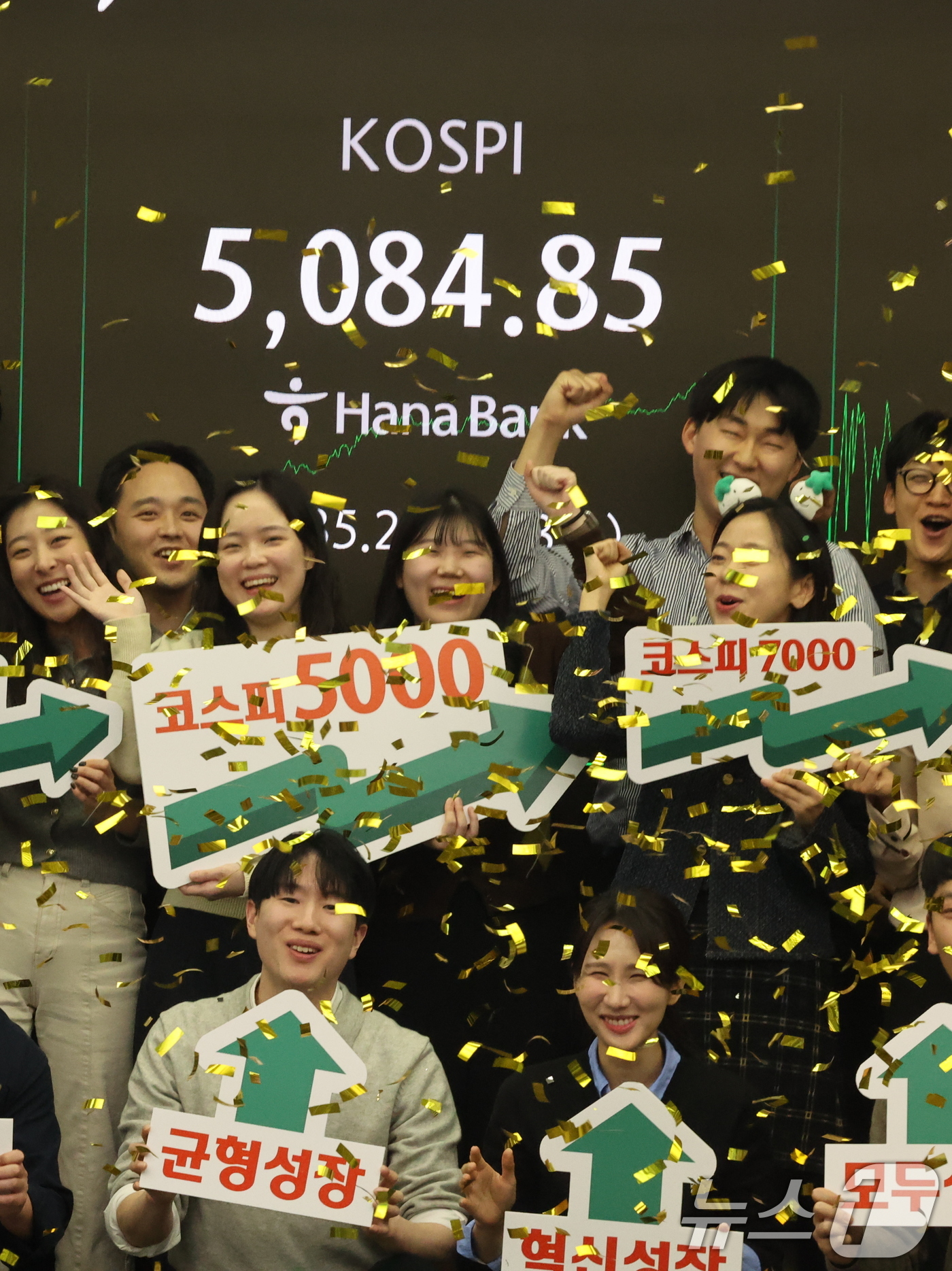 (서울=뉴스1) 황기선 기자 = 코스피가 종가 기준 사상 처음 5000선을 돌파한 27일 오후 서울 중구 하나은행 본점 딜링룸에서 직원들이 축하 세리머니를 하고 있다. 이날 코스피 …