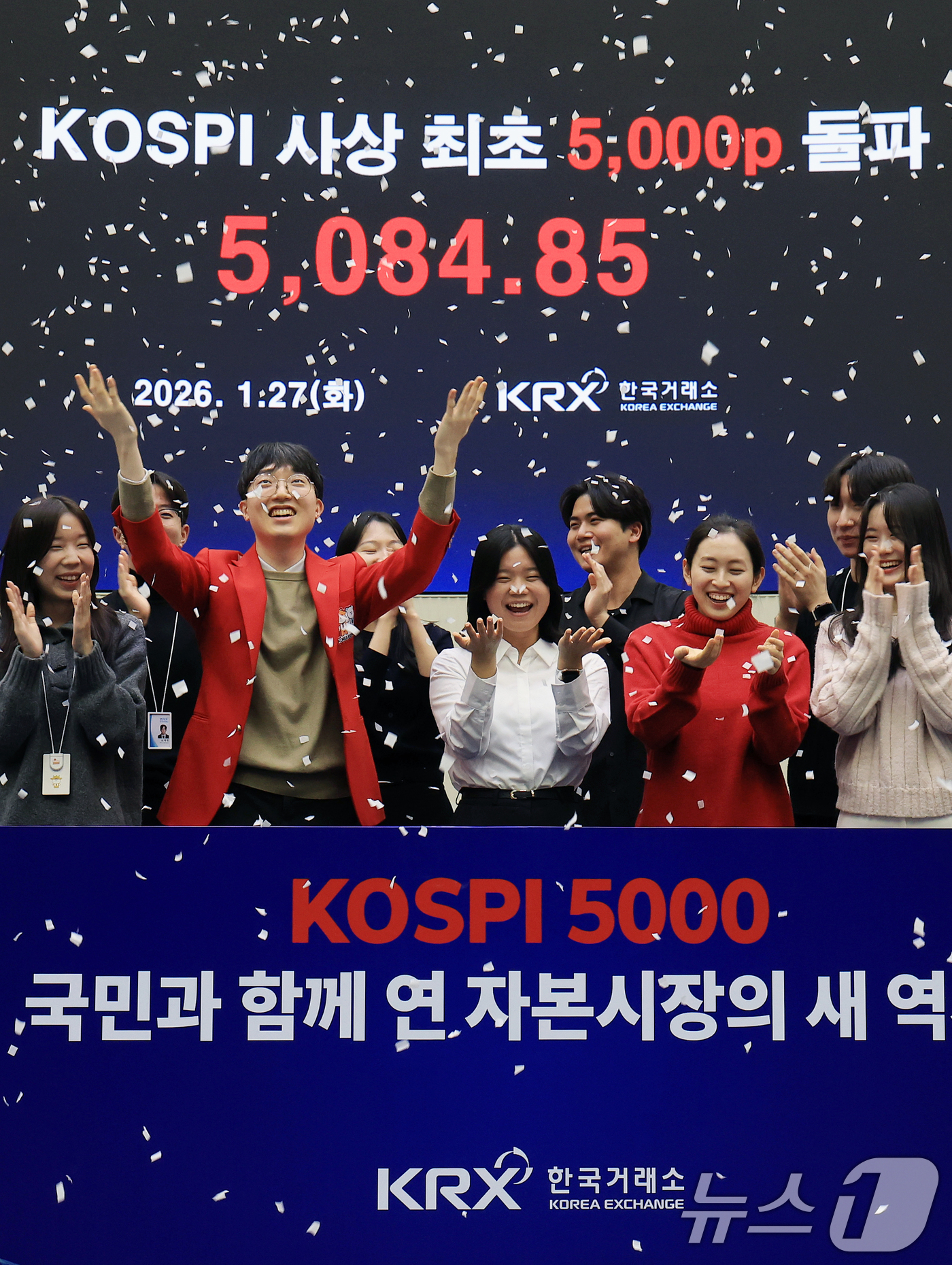 (서울=뉴스1) 이호윤 기자 = 한국 증시 최초로 종가 기준 코스피 5000을 달성한 27일 서울 영등포구 한국거래소에서 직원들이 코스피 종가가 표시된 전광판을 배경으로 세레머니를 …