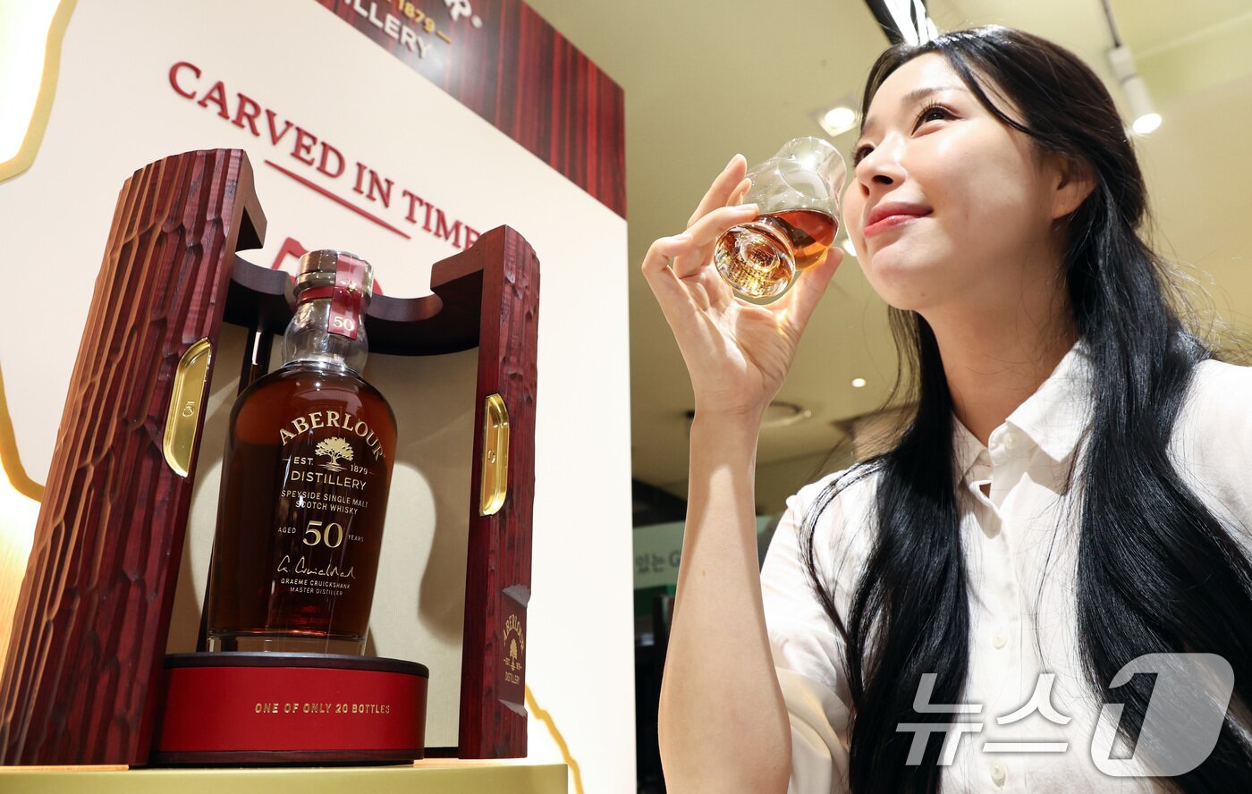 본문 이미지 - 28일 서울 중구 롯데백화점 본점 식품관에서 모델이 설 명절을 맞이해 전세계 단 20병 한정 생산된 '아벨라워 50년산'을 단독으로 선보이고 있다.  2026.1.28/뉴스1 ⓒ News1 최지환 기자