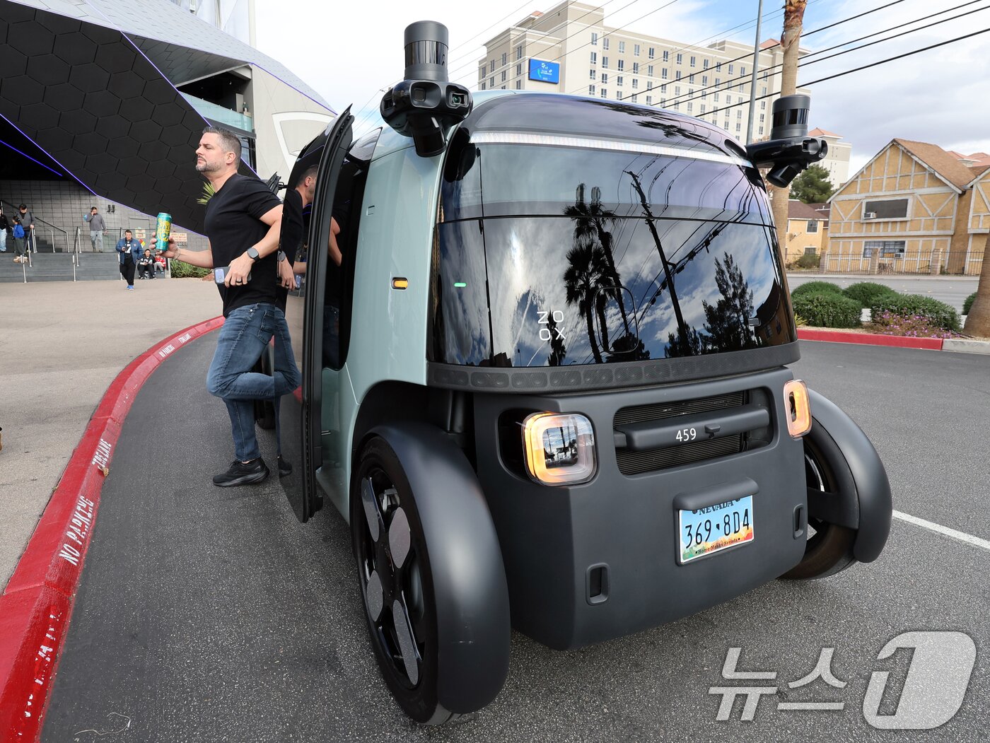 본문 이미지 - 세계 최대 IT(정보기술)·가전 전시회 'CES 2026' 개막을 이틀 앞둔 4일(현지시간) 미국 네바다주 라스베이거스 거리에서 시민이 아마존의 로보택시 '죽스(ZOOX)'에 하차하고 있다.  2026.1.5/뉴스1 ⓒ News1 황기선 기자