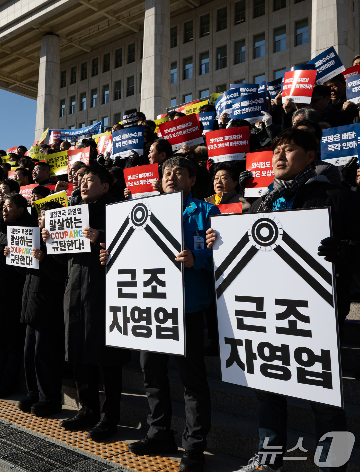 (서울=뉴스1) 유승관 기자 = (사)한국외식업중앙회 등 자영업자를 비롯한 참석자들이 7일 서울 여의도 국회 본청 앞 계단에서 열린 자영업 말살하는 쿠팡 규탄대회에서 구호를 외치고 …
