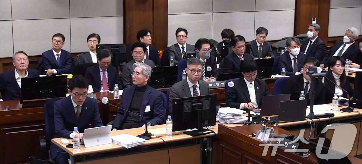 본문 이미지 - 윤석열 전 대통령, 김용현 전 국방부 장관 등이 9일 서울 서초구 서울중앙지방법원에서 열린 내란 우두머리 혐의 1심 결심 공판에 출석해 자리에 앉아 있다. (서울중앙지방법원 제공 영상 캡쳐. 재판매 및 DB 금지) 2026.1.9 ⓒ 뉴스1 임세영 기자