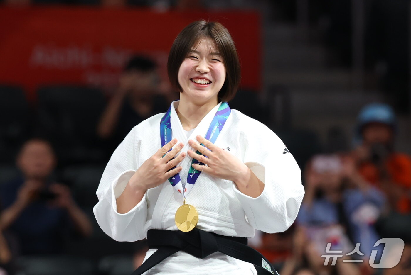 본문 이미지 - 대한민국 허미미가 1일 일본 아이치 인터내셔널 아레나에서 열린 2026 아이치·나고야 아시안게임 유도 여자 57kg급 결승 시상식에서 금메달을 들고 기뻐하고 있다. 2026.10.1 ⓒ 뉴스1 김민지 기자