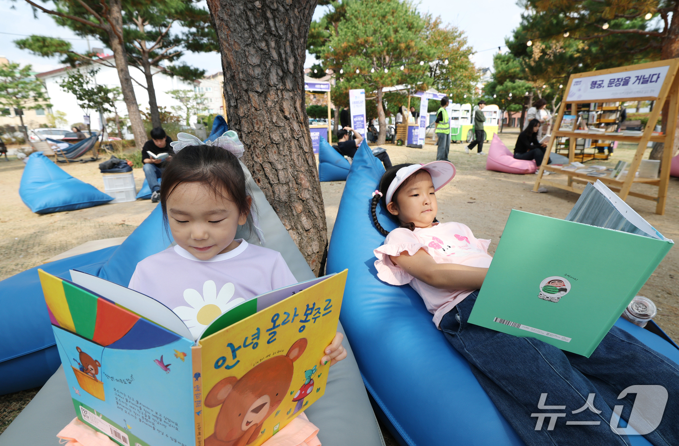 (수원=뉴스1) 김영운 기자 = 완연한 가을 날씨를 보인 16일 경기 수원시 팔달구 수원시립미술관 옆 공원에서 열린 '수원야외도서관 행궁산책'을 찾은 아이들이 독서를 하고 있다.수 …