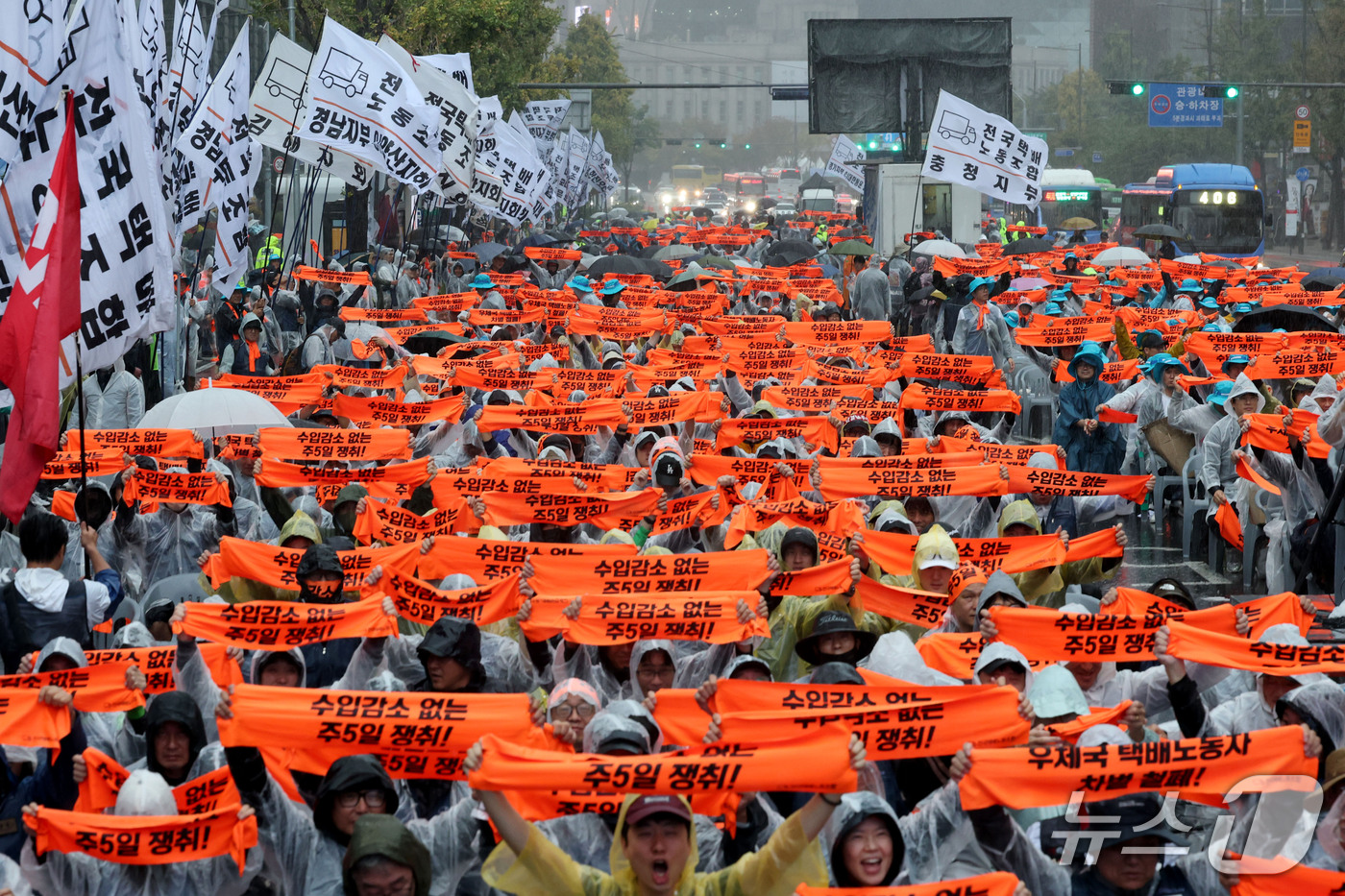 (서울=뉴스1) 이광호 기자 = 18일 오후 서울 중구 숭례문 인근에서 열린 전국택배 노동자대회에서 참가자들이 수입감소 없는 주5일 쟁취 등을 촉구하며 손피켓을 들어보이고 있다. …