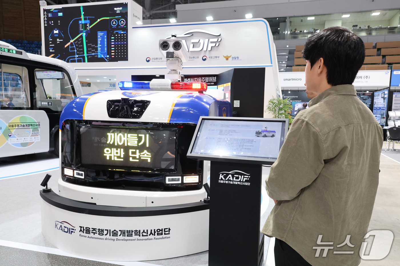 (강릉=뉴스1) 신웅수 기자 = 20일 강원 강릉시 스피드스케이팅경기장에서 열린 강릉 ITS 세계총회에서 관람객들이 인공지능을 활용한 단속 기능이 탑재된 자율주행 경찰 차량을 살펴 …
