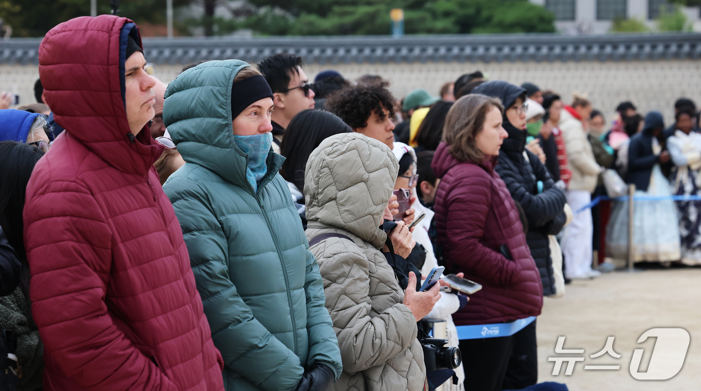 (서울=뉴스1) 오대일 기자 = 29일 오후 서울 종로구 경복궁 흥례문 광장을 찾은 외국인 관광객들이 두터운 패딩을 입은 채 궁궐 호위군 사열의식 '첩종' 리허설 행사를 지켜보고 …