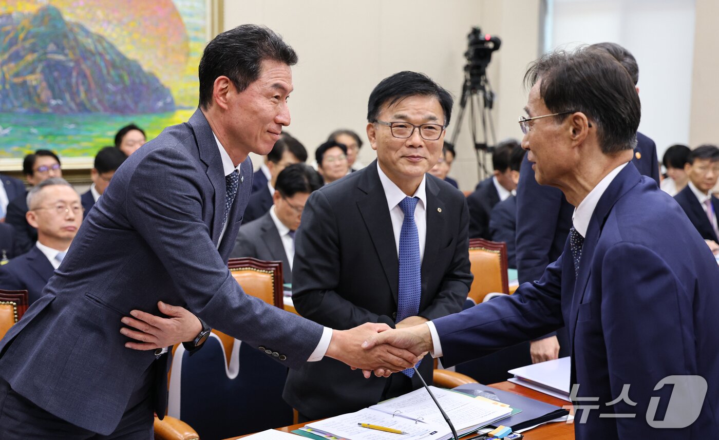 본문 이미지 - 장민영 IBK기업은행장과 박상진 한국산업은행 회장이 8일 서울 여의도 국회에서 열린 정무위원회 국정감사에 출석해 유동수 정무위원장과 인사를 나누고 있다. 2026.10.8 ⓒ 뉴스1 김도우 기자