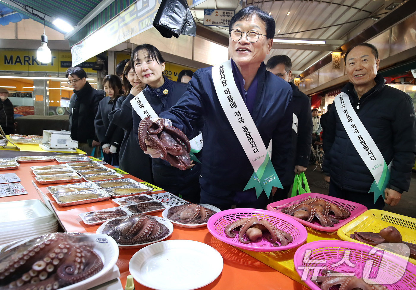 (대구=뉴스1) 공정식 기자 = 10일 오후 대구 수성구 신매시장에서 열린 '설맞이 전통시장 장보기' 행사에 참여한 김대권 수성구청장과 구청 직원들이 어물전에서 제수용 문어를 고르 …