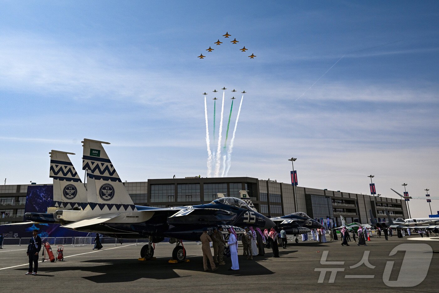 본문 이미지 - 공군은 특수비행팀 블랙이글스가 8일부터 12일(현지시간)까지 사우디아라비아 리야드에서 열린 ‘세계 방위산업 전시회(WDS 2026)’에 참가해 에어쇼를 선보였다고 13일 밝혔다. 사진은 지난 10일(현지시간) 진행된 '블랙이글스-사우디아라비아 호크스 우정비행 행사'에서 한국 블랙이글스 T-50B 7대와 사우디 호크스 항공기 7대가 리야드 컨벤션 센터 상공에서 나란히 비행을 하는 모습. (공군 제공. 재판매 및 DB 금지) 2026.2.13 ⓒ 뉴스1