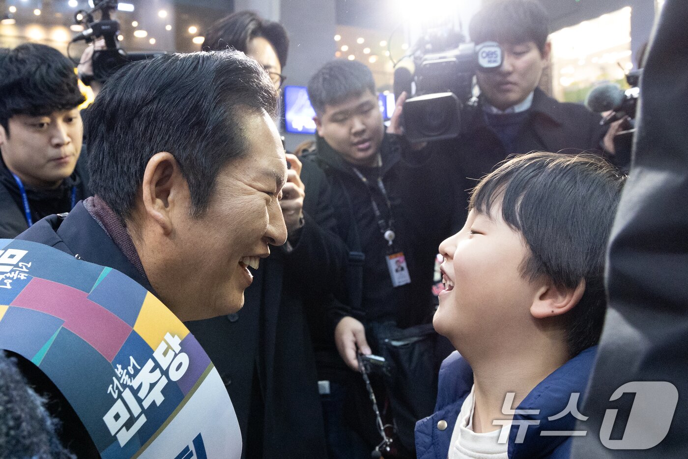 본문 이미지 - 정청래 더불어민주당 대표가 13일 서울 용산역에서 설 귀성객 인사를 하며 아이와 눈을 맞추고 있다. 2026.2.13 ⓒ 뉴스1 이승배 기자