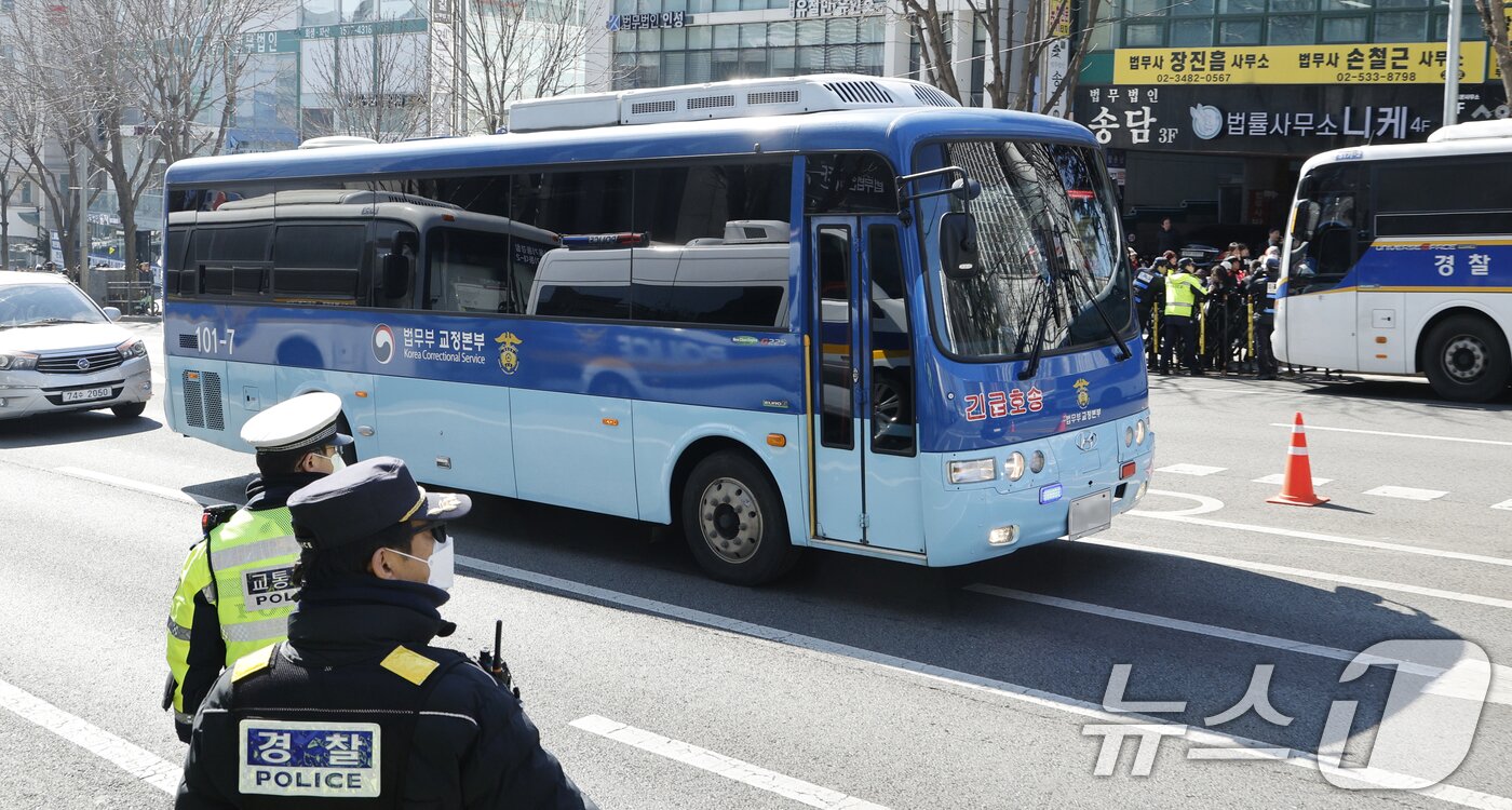 본문 이미지 - 윤석열 전 대통령을 태운 호송차가 19일 오후 서울 서초구 중앙지방법원에 도착하고 있다. 서울중앙지법 형사합의25부(부장판사 지귀연)는 이날 오후 3시부터 417호 형사대법정에서 윤 전 대통령의 12·3 비상계엄 관련 내란 우두머리 등 혐의 1심 판결을 선고한다. 2026.2.19 ⓒ 뉴스1 안은나 기자