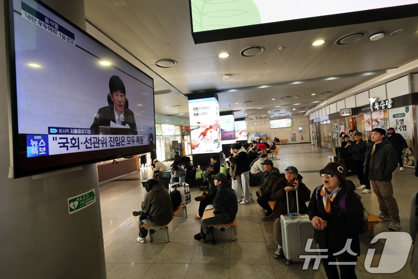 (광주=뉴스1) 박지현 기자 = 19일 오후 광주 서구 광천동 유스퀘어복합터미널에서 시민들이 윤석열 전 대통령의 내란 우두머리 혐의 1심 선고 생중계를 지켜보고 있다. 2026.2 …