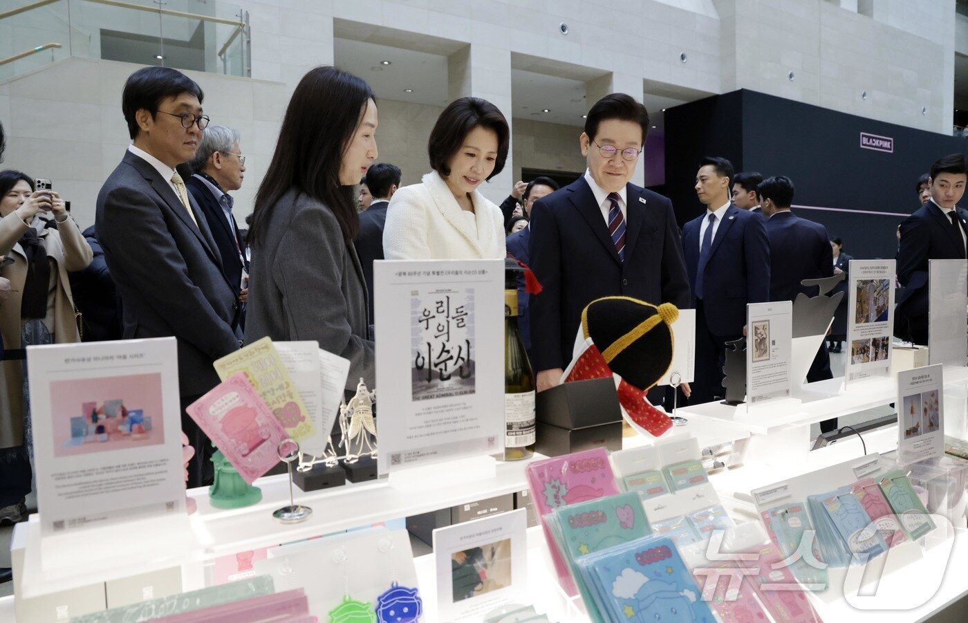 본문 이미지 - 이재명 대통령과 김혜경 여사가 26일 서울 용산구 국립중앙박물관에서 열린 특별전 '우리들의 이순신'을 관람한 뒤 기념품을 들고 기념촬영을 하고 있다. 2026.2.26 ⓒ 뉴스1 허경 기자