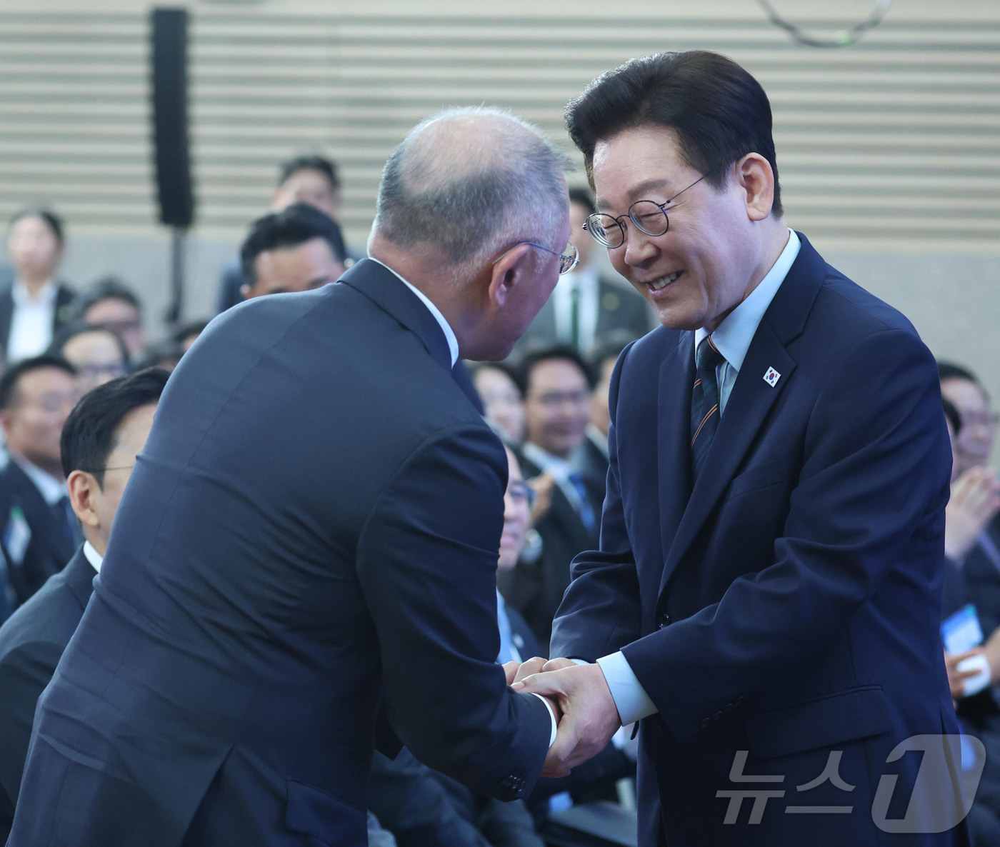 (군산=뉴스1) 이재명 기자 = 이재명 대통령이 27일 전북 군산시 새만금 컨벤션센터에서 열린 새만금 로봇·수소·AI 시티 투자협약식에서 정의선 현대자동차 회장과 악수를 하고 있다 …