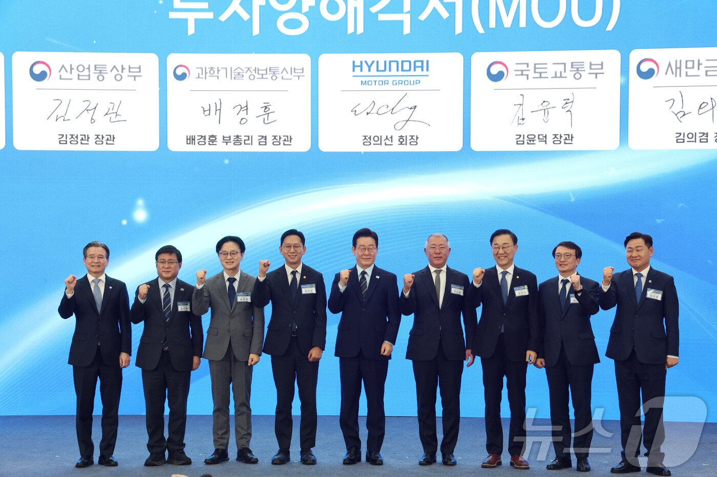 본문 이미지 - 이재명 대통령과 정의선 현대자동차 회장이 27일 전북 군산시 새만금 컨벤션센터에서 열린 새만금 로봇·수소·AI 시티 투자협약식에서 투자협약을 체결한 뒤 기념촬영을 하고 있다. 왼쪽부터 김용범 정책실장, 김성환 기후에너지환경부 장관, 김정관 산업통상부 장관, 배경훈 부총리 겸 과학기술정보통신부 장관, 이재명 대통령, 정의선 현대자동차 회장, 김윤덕 국토교통부 장관, 김의겸 새만금청장, 김관영 전북도지사. 2026.2.27 ⓒ 뉴스1 이재명 기자