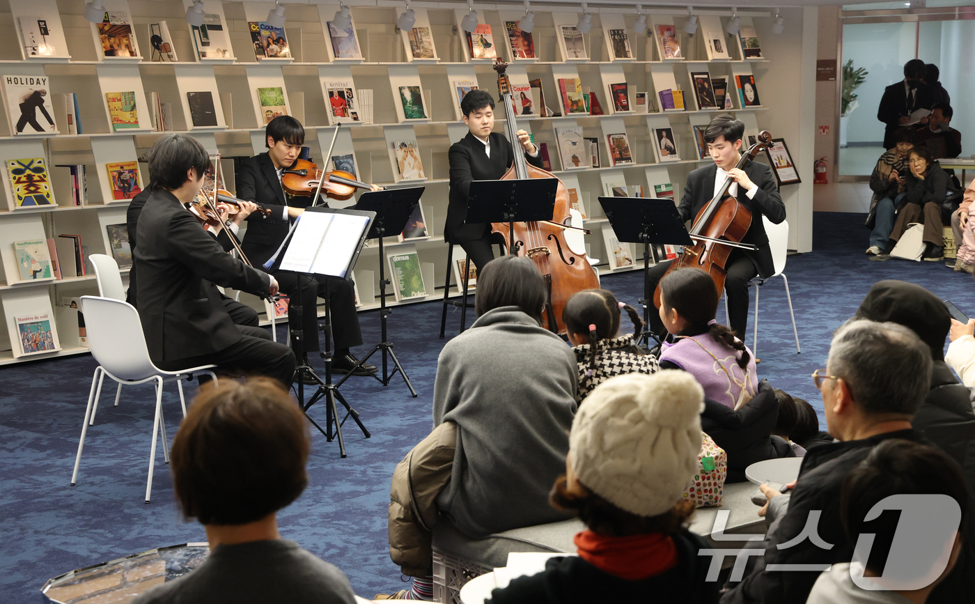 (수원=뉴스1) 김영운 기자 = 6일 경기 수원시 영통구 경기도서관 힙플레이스에서 열린 '예술로 소통하다' 특별공연에서 시민들이 경기리베라오케스트라의 아름다운 현악 5중주 연주를 …