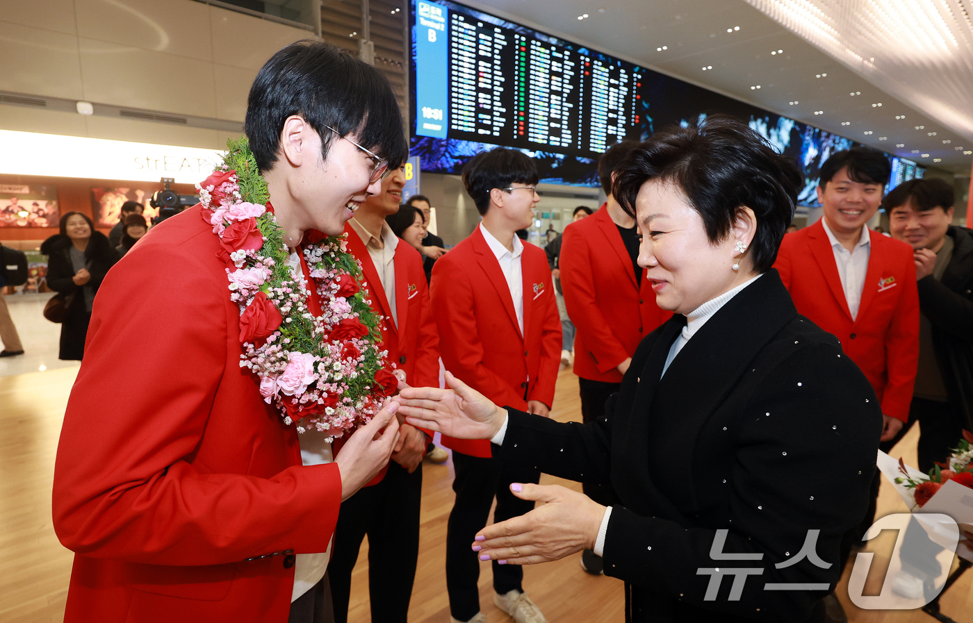 (인천공항=뉴스1) 이호윤 기자 = 신진서 9단이 7일 인천공항 제2터미널을 통해 입국해 이광순 한국여성바둑연맹 회장에게 꽃목걸이를 받고 있다.신 9단은 지난 6일 중국 선전 힐튼 …