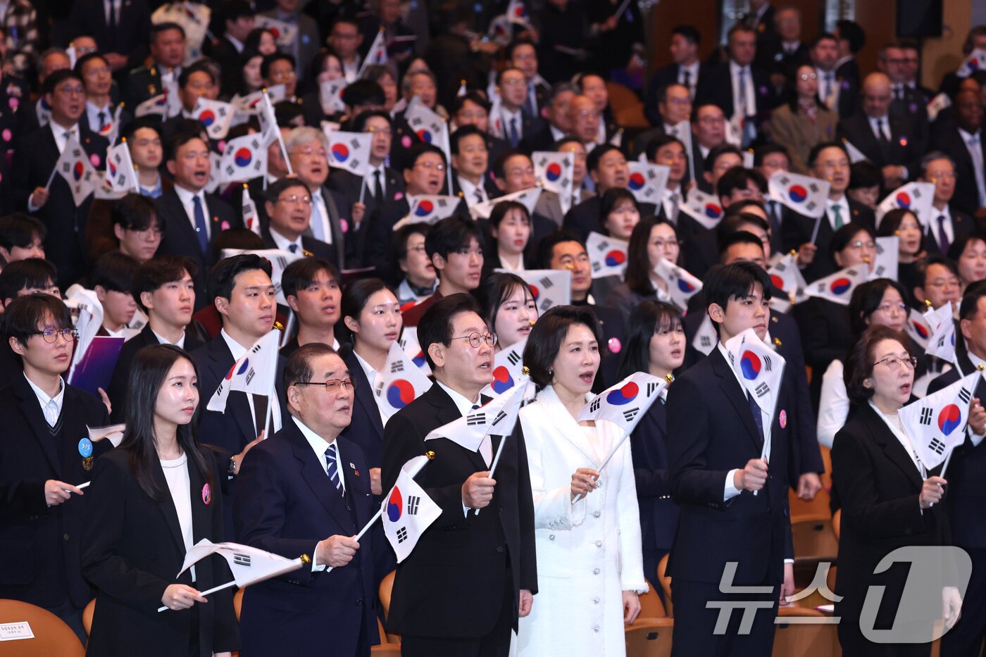 본문 이미지 - 이재명 대통령과 김혜경 여사가 1일 서울 강남구 코엑스에서 열린 제107주년 3·1절 기념식에서 참석자들과 3·1절 노래를 제창하고 있다. 2026.3.1 ⓒ 뉴스1 이재명 기자