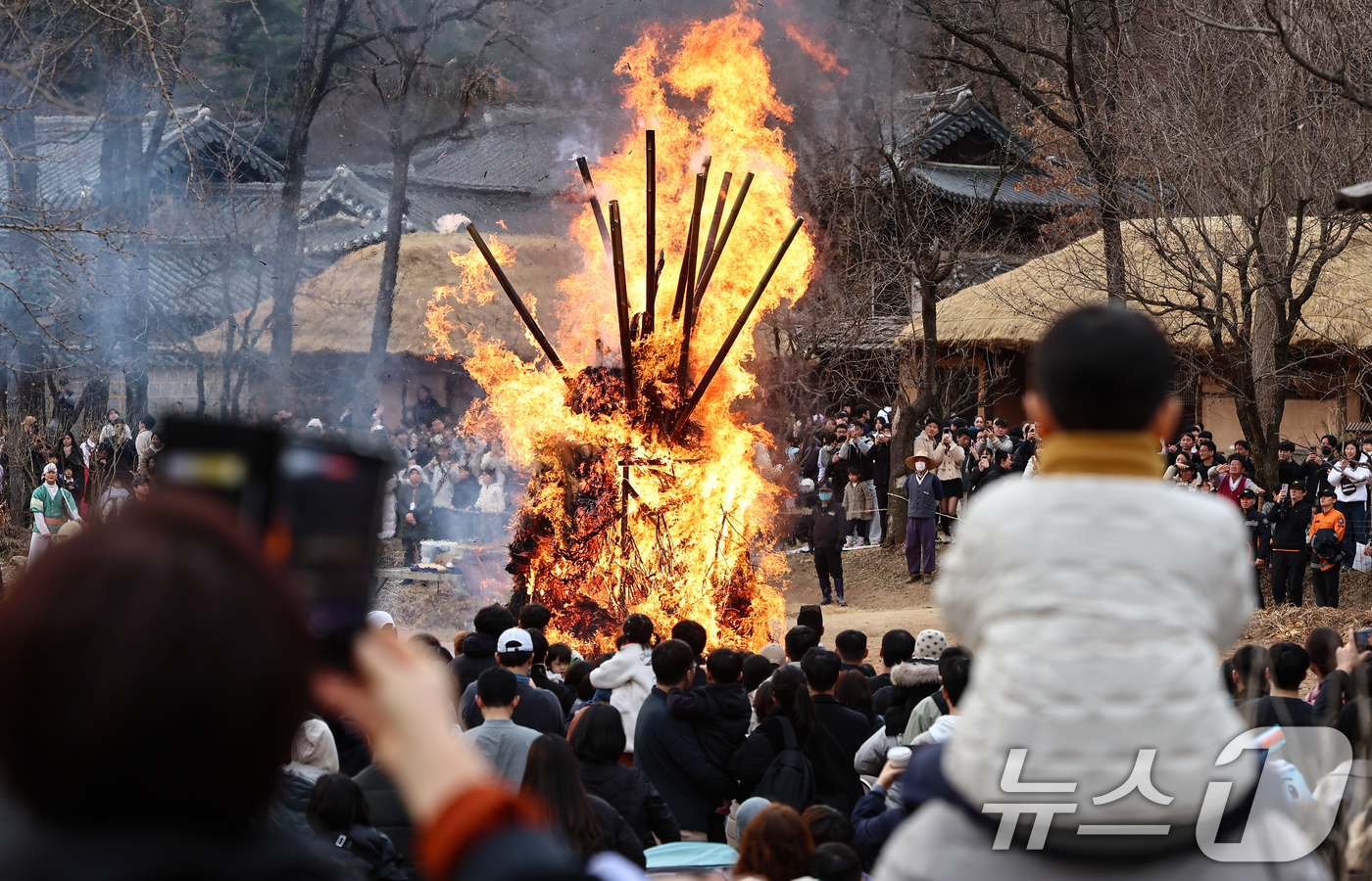 (용인=뉴스1) 김도우 기자 = 정월대보름을 이틀 앞둔 1일 경기 용인시 기흥구 한국민속촌에서 열린 달집태우기 행사에서 시민들이 타오르는 달집을 바라보며 소원을 빌고 있다. 202 …