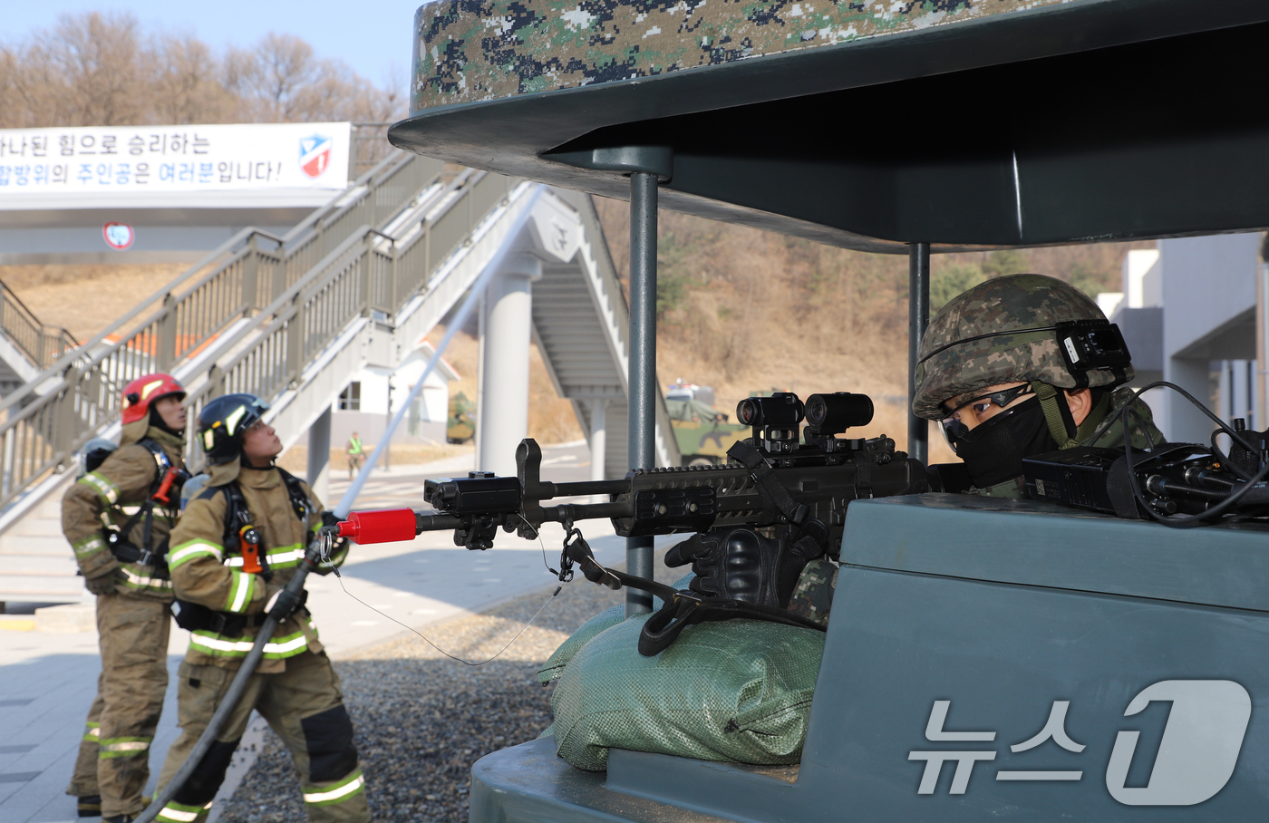 (서울=뉴스1) = 12일 인천도시지역전투훈련장에서 진행된 통합방위작전 훈련에서 병원에 발생한 화재 진압을 위해 17사단 승리여단의 경계 지원 아래 김포소방서가 소화 작업을 진행하 …