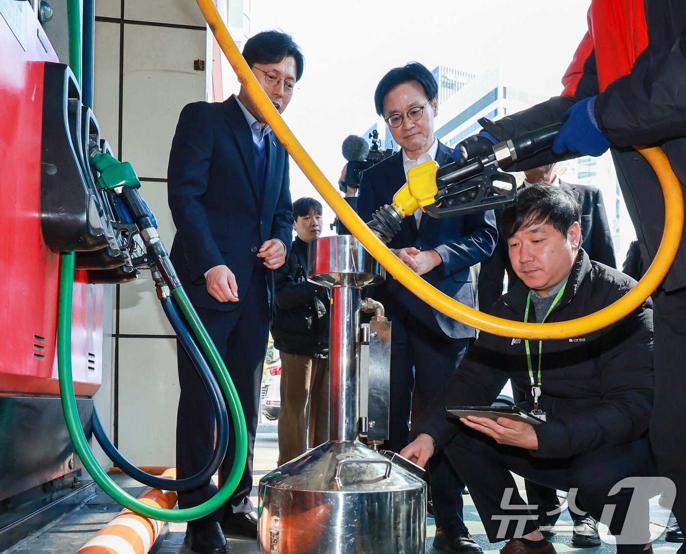 본문 이미지 - 김정관 산업통상부 장관이 석유 최고가격제 시행 첫날인 13일 서울 마포구 SK에너지 양지주유소를 찾아 정량기준탱크를 보며 한국석유관리원 관계자의 설명을 듣고 있다. 2026.3.13 ⓒ 뉴스1 안은나 기자