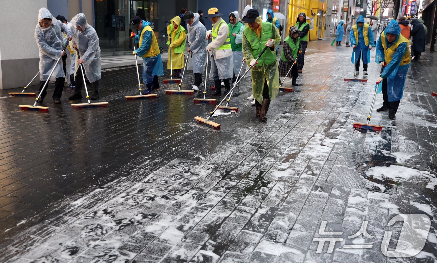 (서울=뉴스1) 김명섭 기자 = 18일 서울 중구 명동에서 중구청 직원 및 상인들이 오는 21일 열리는 BTS공연 및 봄철 관광객 맞이 물청소를 하고 있다.  2026.3.18/뉴 …