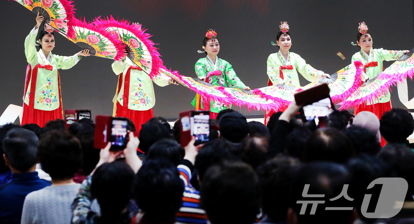 (대구=뉴스1) 공정식 기자 = 춘분(春分)을 이틀 앞둔 18일 대구 달서구 월배노인종합복지관에서 열린 '새봄맞이 특별공연'을 찾은 어르신들이 휴대전화 카메라로 한복 차림의 부채춤 …