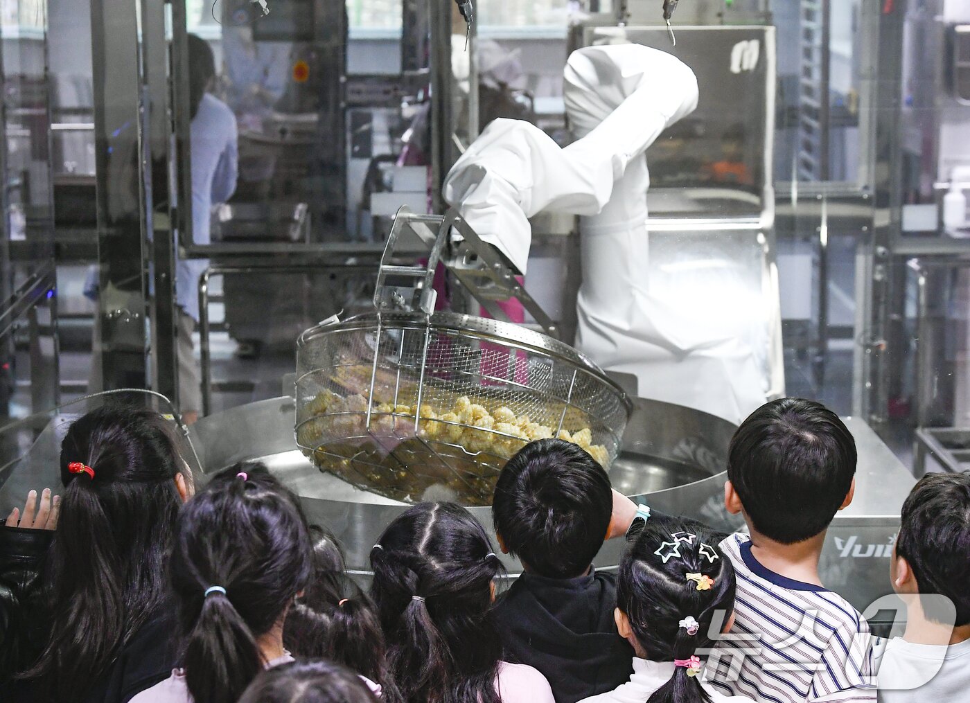 본문 이미지 - 18일 경기 수원시 장안구 대평초등학교 내 위치한 거점형 학교급식 튀김 지원실에서 1학년 학생들이 튀김 조리 로봇이 직접 가동되는 현장을 보고 있다. (공동취재) 2026.3.18 ⓒ 뉴스1 김영운 기자