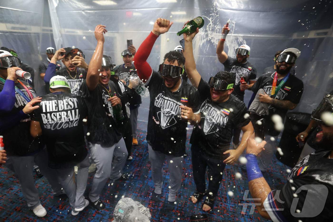 본문 이미지 - 베네수엘라 선수들이 18일(한국시간) 2026 WBC 우승을 차지한 뒤 샴페인 파티를 벌이고 있다. ⓒ AFP=뉴스1