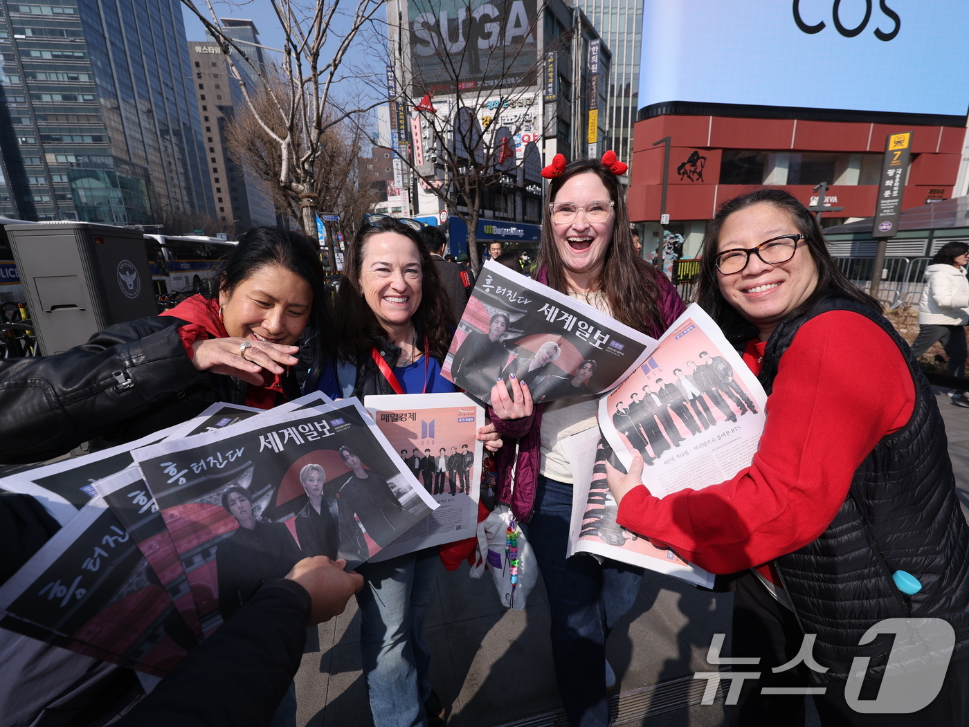 (서울=뉴스1) 박지혜 기자 = 방탄소년단(BTS) 컴백 공연일인 21일 오전 서울 광화문광장에서 외국인 관광객들이 주요 일간지들이 발행한 BTS 특별판을 들어보이고 있다. 202 …