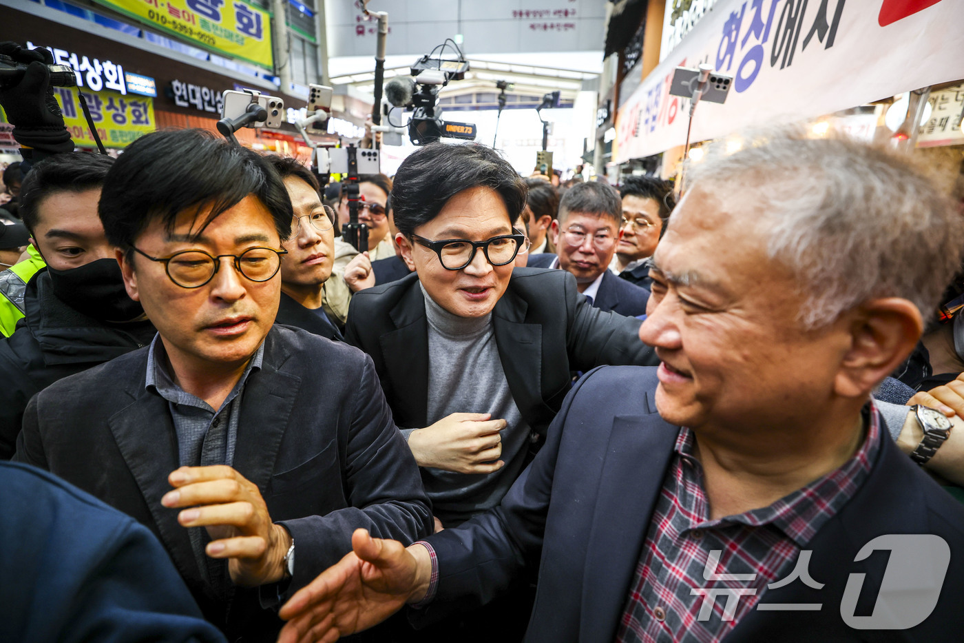 (서울=뉴스1) 최지환 기자 = 한동훈 전 국민의힘 대표가 22일 서울 동대문구 경동시장을 찾아 지지자 및 시장 상인들과 인사를 나누고 있다.  (공동취재) 2026.3.22/뉴스 …