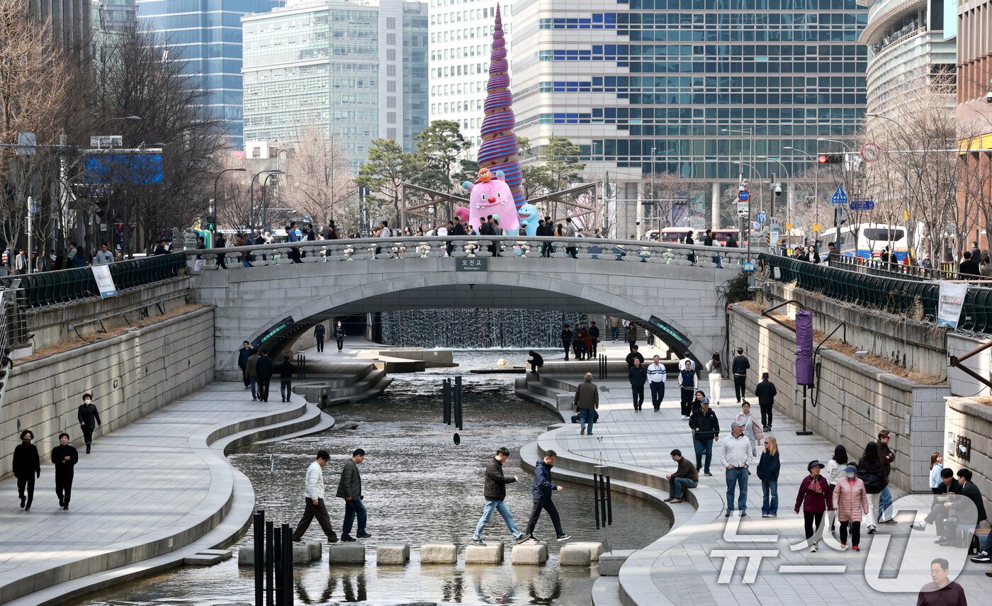 본문 이미지 - 완연한 봄 날씨를 보인 23일 서울 종로구 청계천을 찾은 시민들이 산책을 하고 있다. 2026.3.23 ⓒ 뉴스1 이호윤 기자