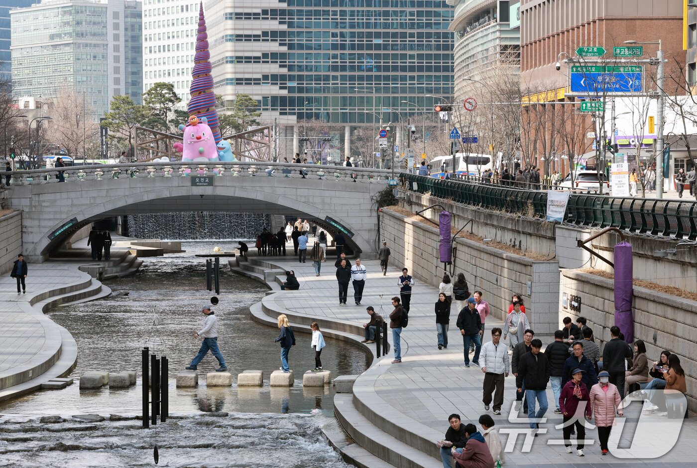 본문 이미지 - 완연한 봄 날씨를 보인 23일 서울 종로구 청계천을 찾은 시민들이 산책을 하고 있다. 2026.3.23 ⓒ 뉴스1 이호윤 기자