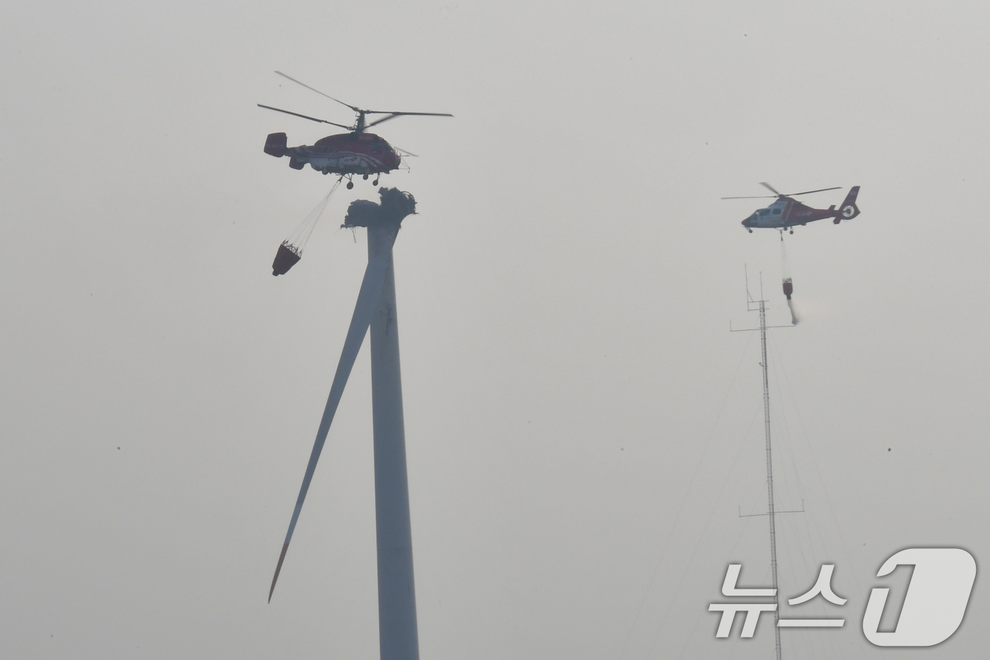 (영덕=뉴스1) 최창호 기자 = 23일 오후 경북 영덕군 창포리 풍력발전단지 내 풍력발전기에서 발생한 화재 진화를 위해 산림청, 소방, 인근 지자체 진화핼기들이 진화 작업을 벌이고 …