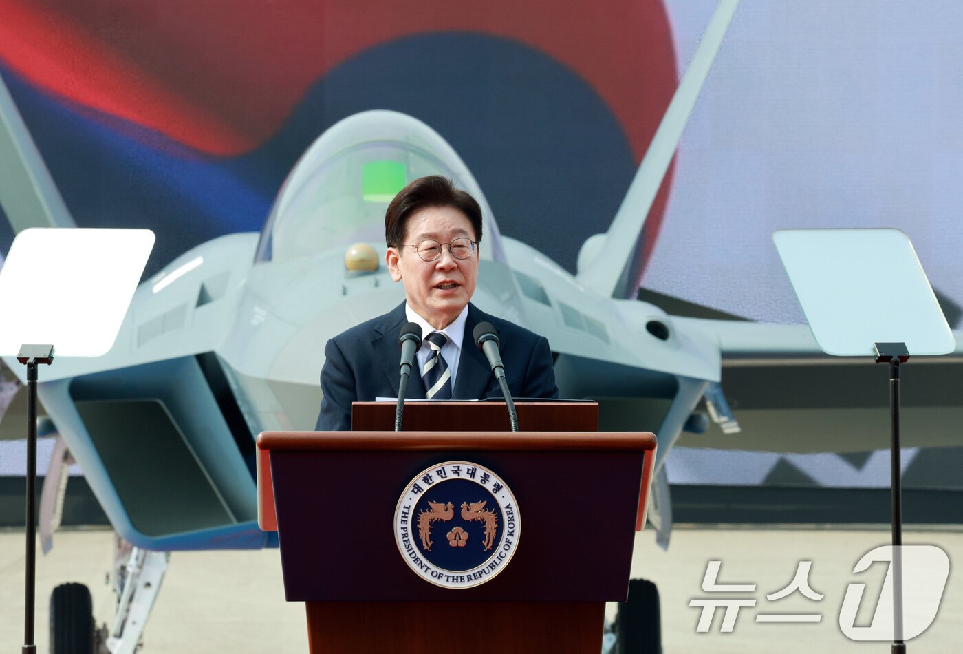 본문 이미지 - 이재명 대통령이 지난 3월 25일 경남 사천 한국항공우주산업에서 열린 KF-21 양산 1호기 출고식에서 격려사를 하고 있다. 2026.3.25 ⓒ 뉴스1 이재명 기자