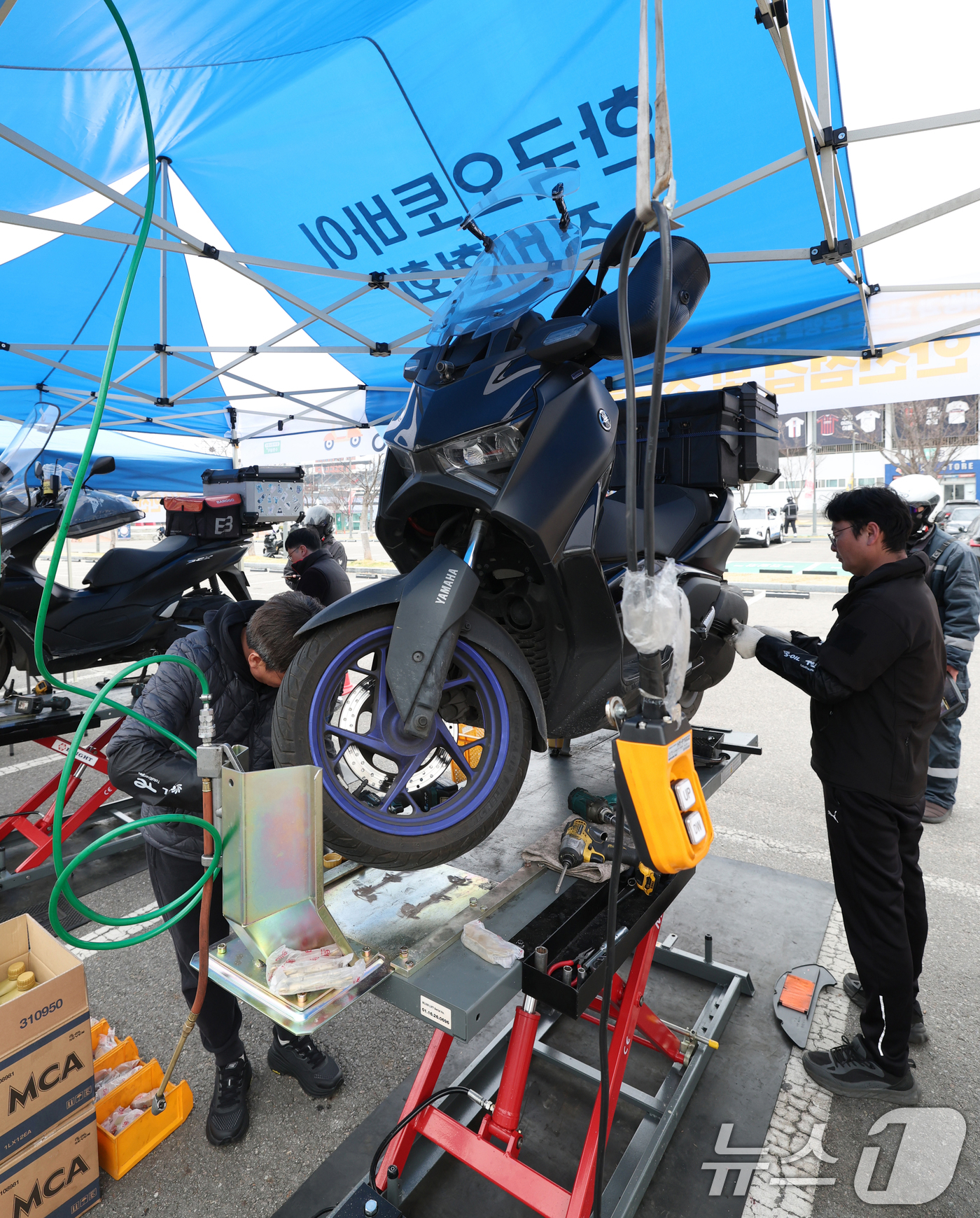 (수원=뉴스1) 김영운 기자 = 30일 경기 수원시 장안구 수원종합운동장에서 열린 '이륜차 사고 예방과 친환경운행을 위한 무상 안전점검 및 소모품 교체 행사'에서 배달 노동자들이 …