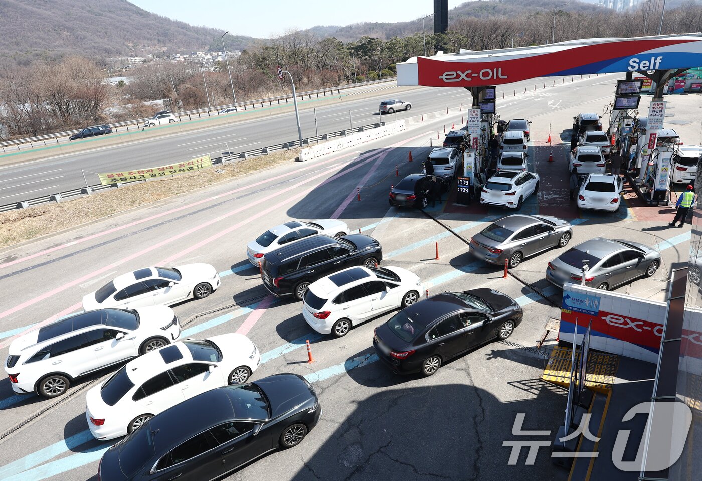 본문 이미지 - 미국·이스라엘과 이란 간 무력 충돌 여파로 국내 휘발유와 경유 가격이 상승하고 있는 가운데 8일 오후 서울 서초구 만남의광장 주유소에 차량들이 주유를 위해 줄지어 서 있다. 2026.3.8 ⓒ 뉴스1 김민지 기자