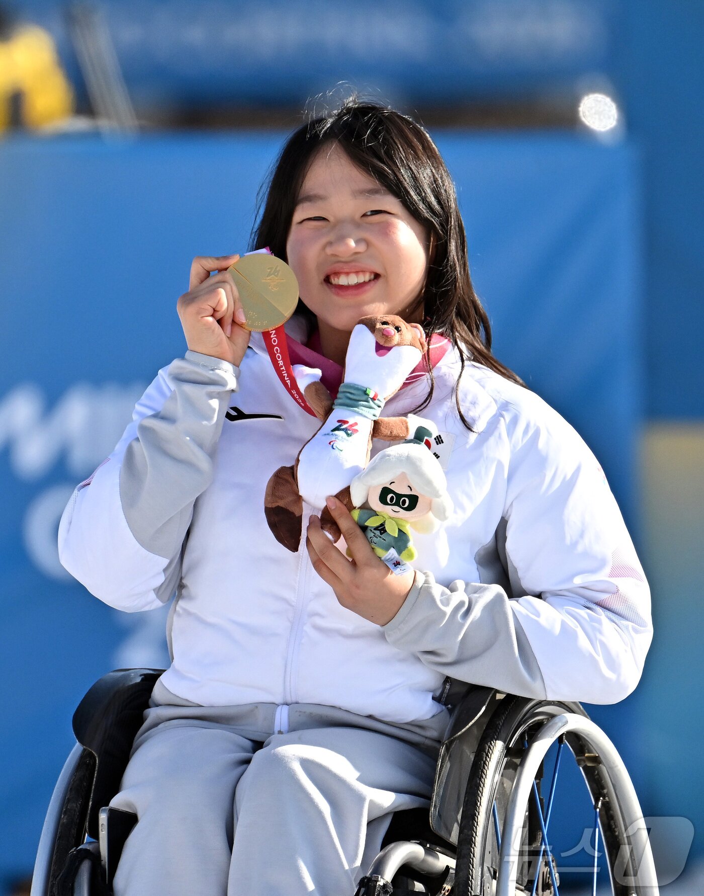 본문 이미지 - 바이애슬론 김윤지가 8일(현지시간) 이탈리아 테세로 크로스컨트리 스키 스타디움에서 열린 2026 밀라노 코르티나 동계패럴림픽 바이애슬론 12.5km 시상식에서 금메달을 들어보이고 있다. 2026.3.9 ⓒ 뉴스1 사진공동취재단