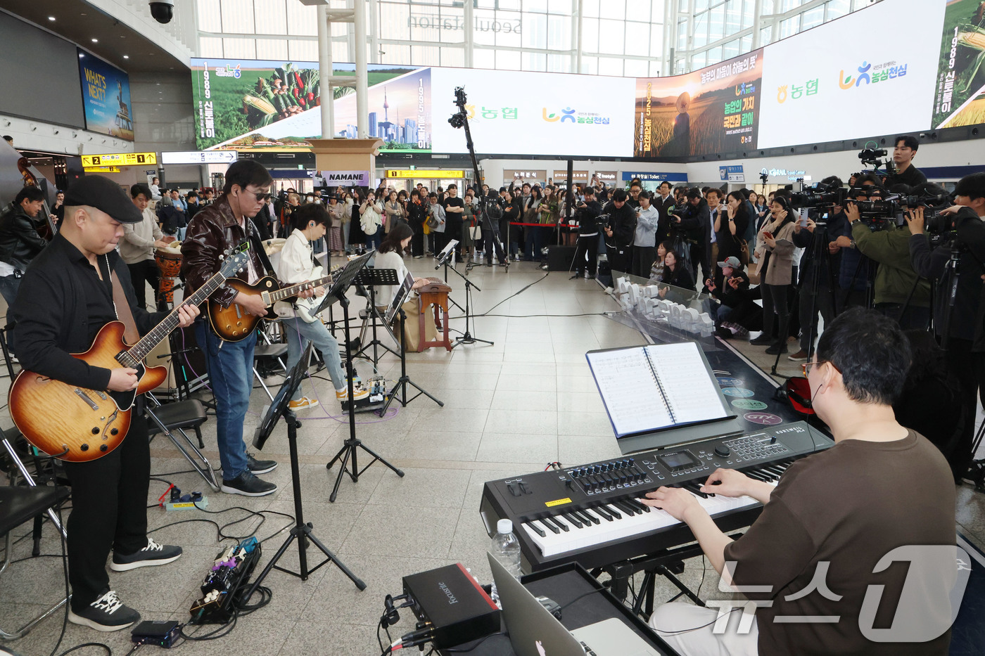 (서울=뉴스1) 이광호 기자 = 최휘영 문화체육관광부 장관이 1일 오후 서울 중구 서울역에서 열린 '문화가 있는 날' 확대 기념 행사에서 기타를 연주하며 공연에 참여하고 있다. …