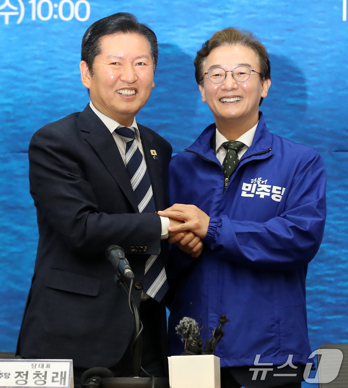 (부산=뉴스1) 윤일지 기자 = 정청래 더불어민주당 대표가 15일 부산 동구 부산항국제전시컨벤션센터에서 열린 부산 현장 최고위원회의에서 전재수 부산시장 후보에게 당 점퍼를 입혀준 …