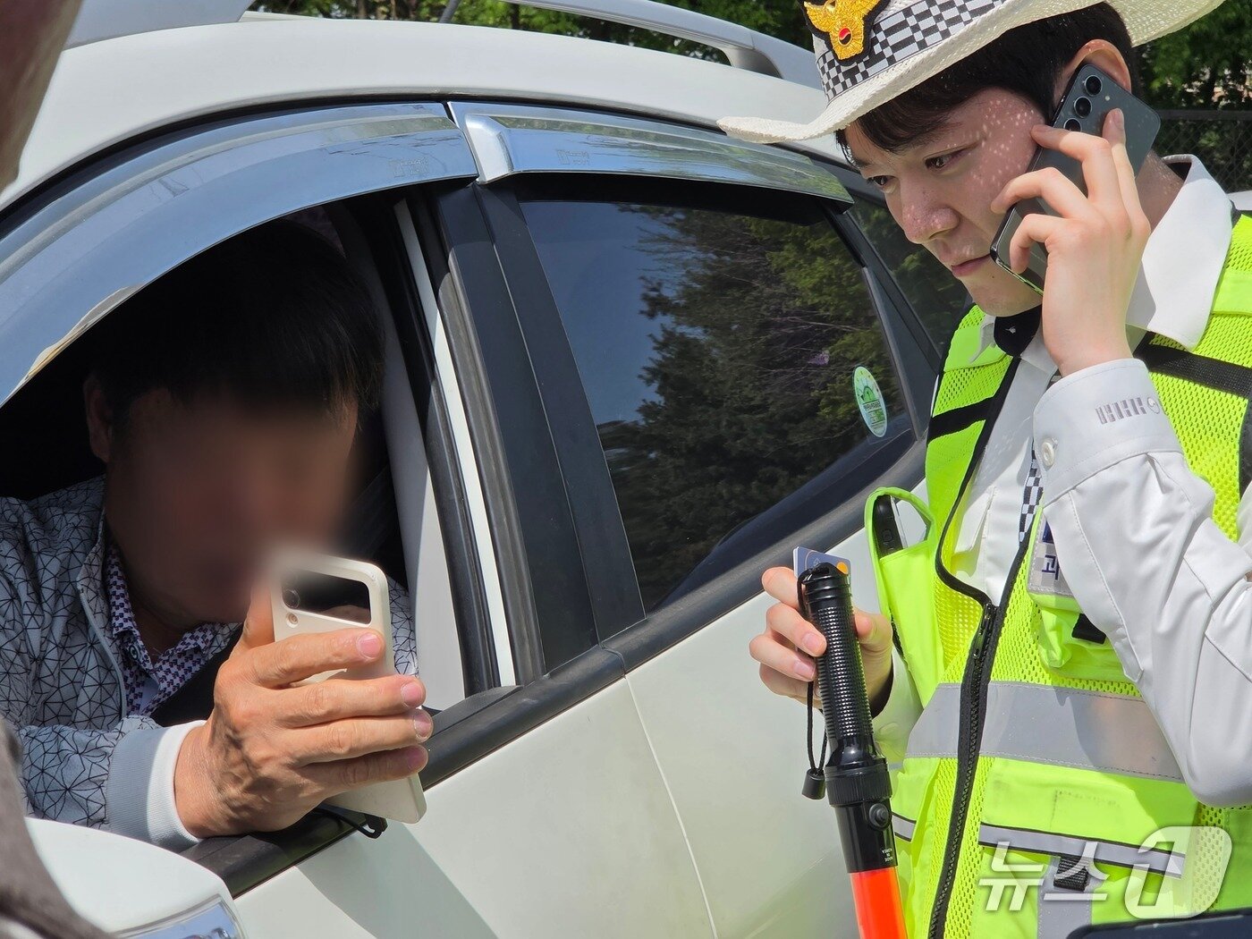 본문 이미지 - 김정훈 서울 강서경찰서 교통관리계 경장이 적발된 운전자에게 납부 방법을 설명하고 있다. 2026.4.16 ⓒ 뉴스1 권준언 기자 