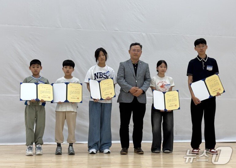 본문 이미지 - 공산초 총동문회 주관으로 입학축하금 전달식에서 입학축하금을 받은 학생들이 동문회 관계자와 기념사진을 찍고 있다.(전남교육청 제공, 재판매 및 DB금지)/뉴스1 