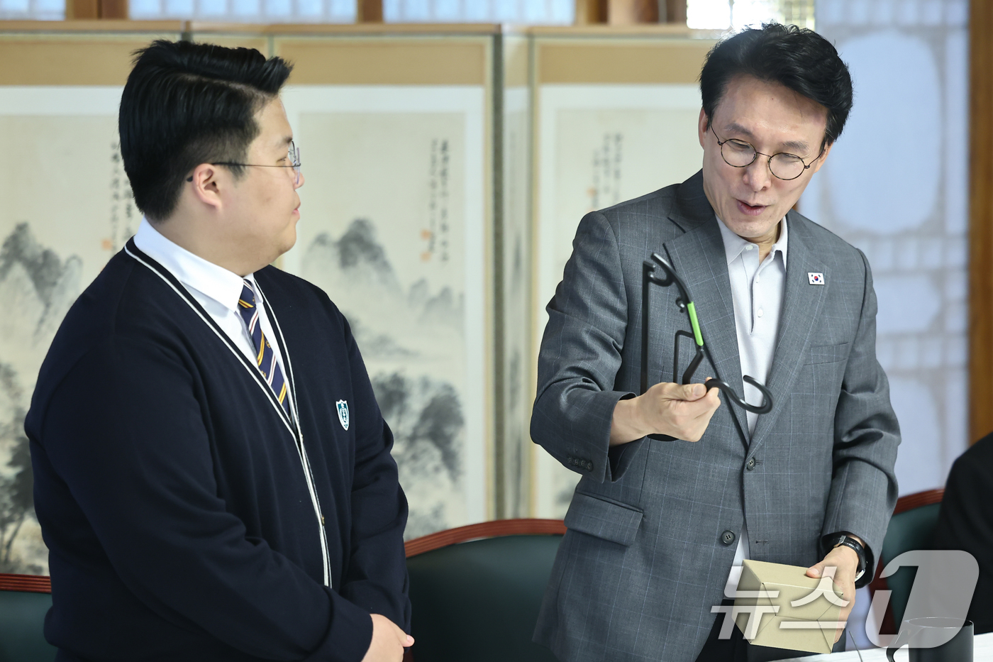 (서울=뉴스1) 김도우 기자 = 김민석 국무총리가 18일 서울 종로구 총리공관에서 열린 삼청동 오픈하우스 청소년·청년기후협의체와 간담회에서 참석한 학생에게 탄소중립 소재로 제작된 …