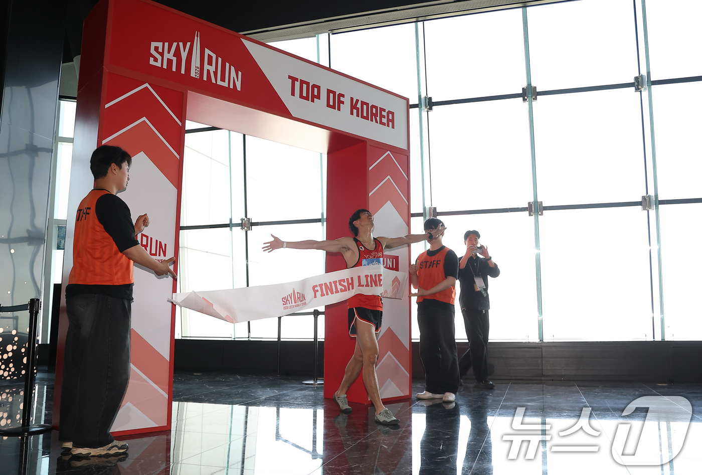 (서울=뉴스1) 황기선 기자 = 19일 서울 송파구 롯데월드타워에서 열린 수직 마라톤 대회 '2026 롯데월드타워 스카이런' 행사에서 한 참가자가 결승선을 지나고 있다.스카이런은 …