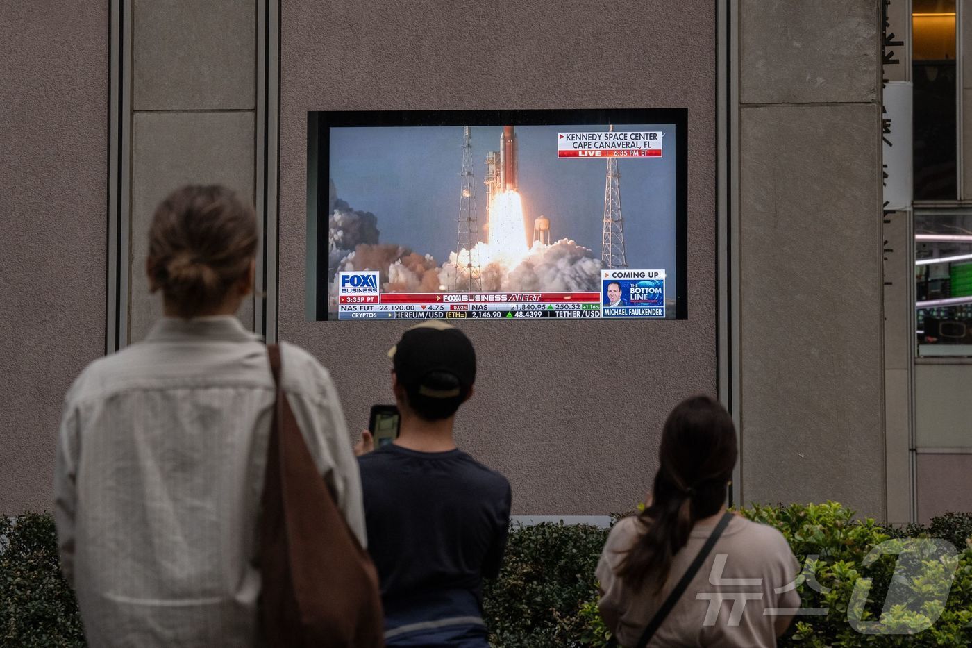 본문 이미지 - 시민들이 2일(한국시간) 미국 미국 플로리다주 케이프 캐너버럴의 케네디 우주센터에서 발사된 아르테미스 2호를 TV 생중계로 지켜보고 있다.ⓒ AFP=뉴스1