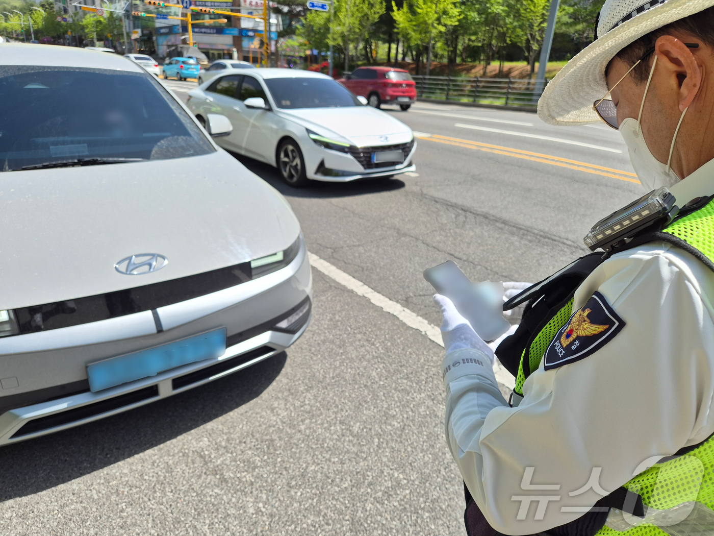 (울산=뉴스1) 박정현 기자 = 21일 오후 울산북부경찰서 교통경찰이 북구 화봉휴먼시아 앞 사거리에서 빨간불 우회전 시 일시 정지하지 않은 SUV를 잡아 세워 범칙금을 부과하고 있 …