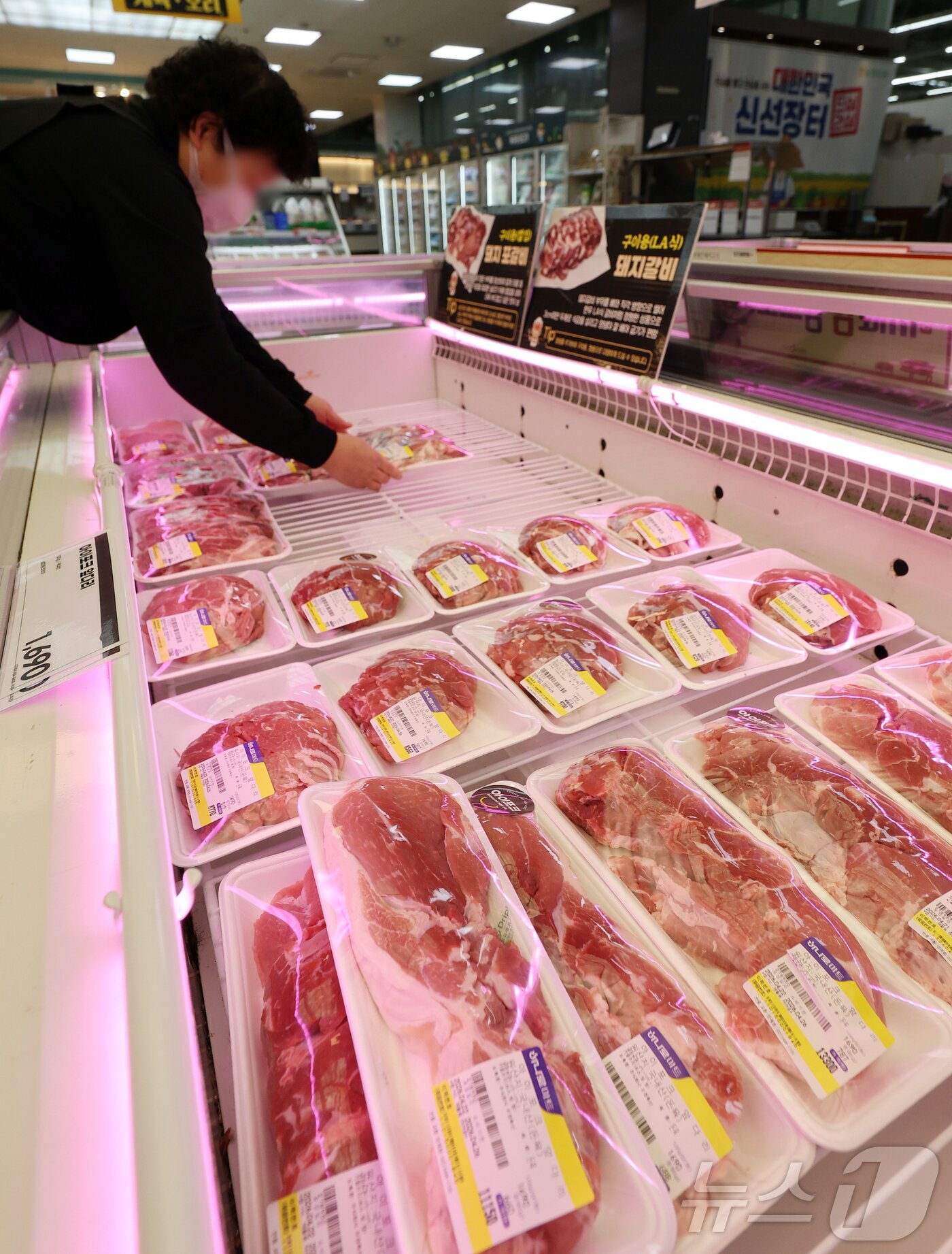 본문 이미지 - 사진은 22일 서울 서초구 농협하나로마트 양재점에서 마트 관계자가 돼지고기를 진열하고 있다. 2026.4.22 ⓒ 뉴스1 김진환 기자